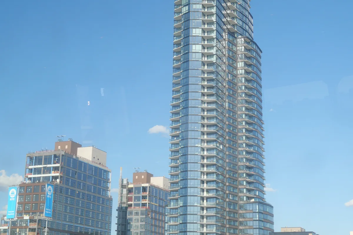The Greenpoint tower and neighboring Greenpoint Landing waterfront buildings seen from the East River