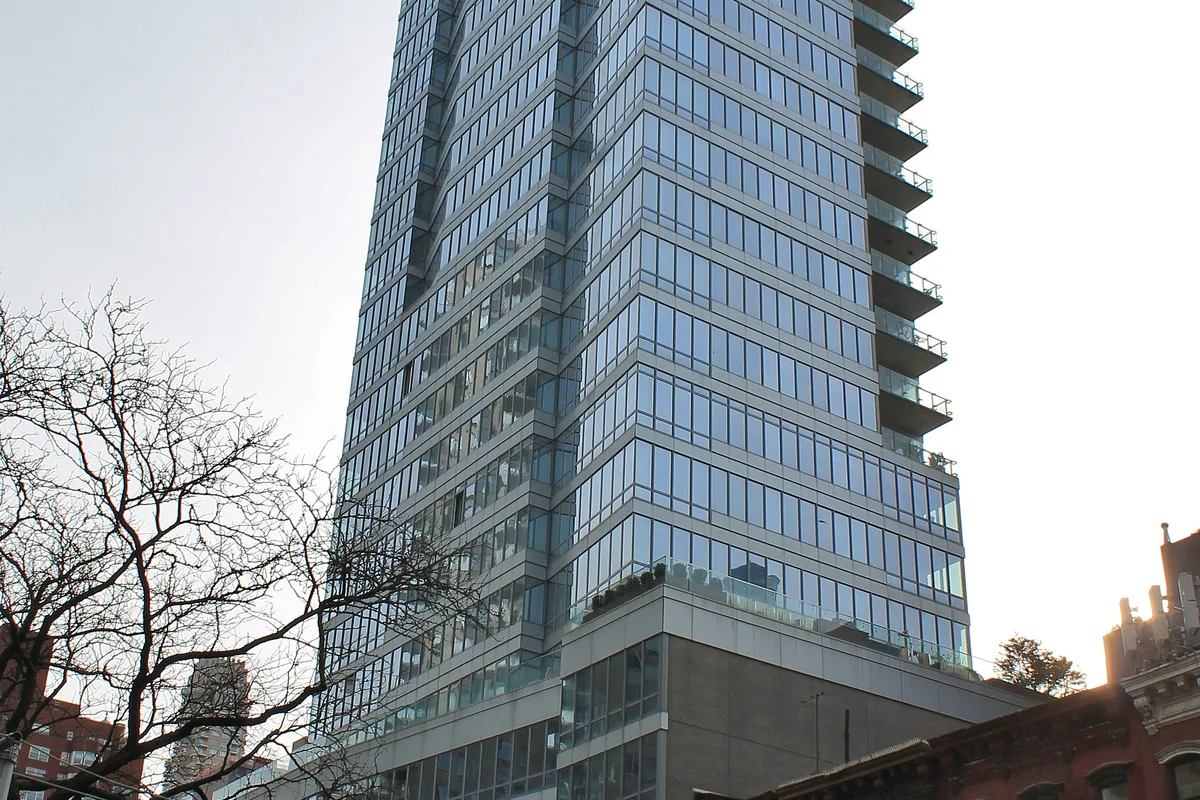 Casa 74 condominium tower seen from the street, April 2021