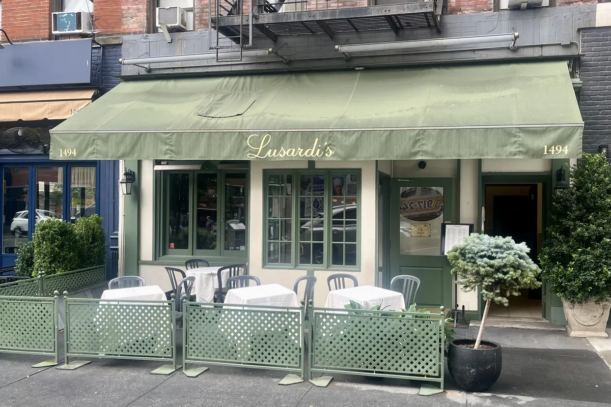 Lusardi's restaurant with its green awning and sidewalk tables at 1494 Second Avenue, across the avenue from the building (the neighborhood, not the building)