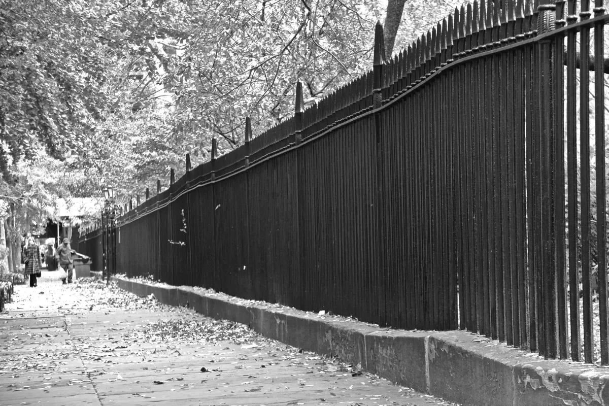 The iron fence and locked perimeter of Gramercy Park along the sidewalk (the park, not the building)