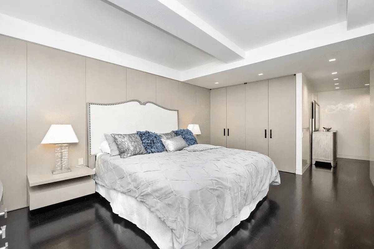 Primary bedroom with upholstered headboard and built-in closets at 40 East 61st Street, unit 6C