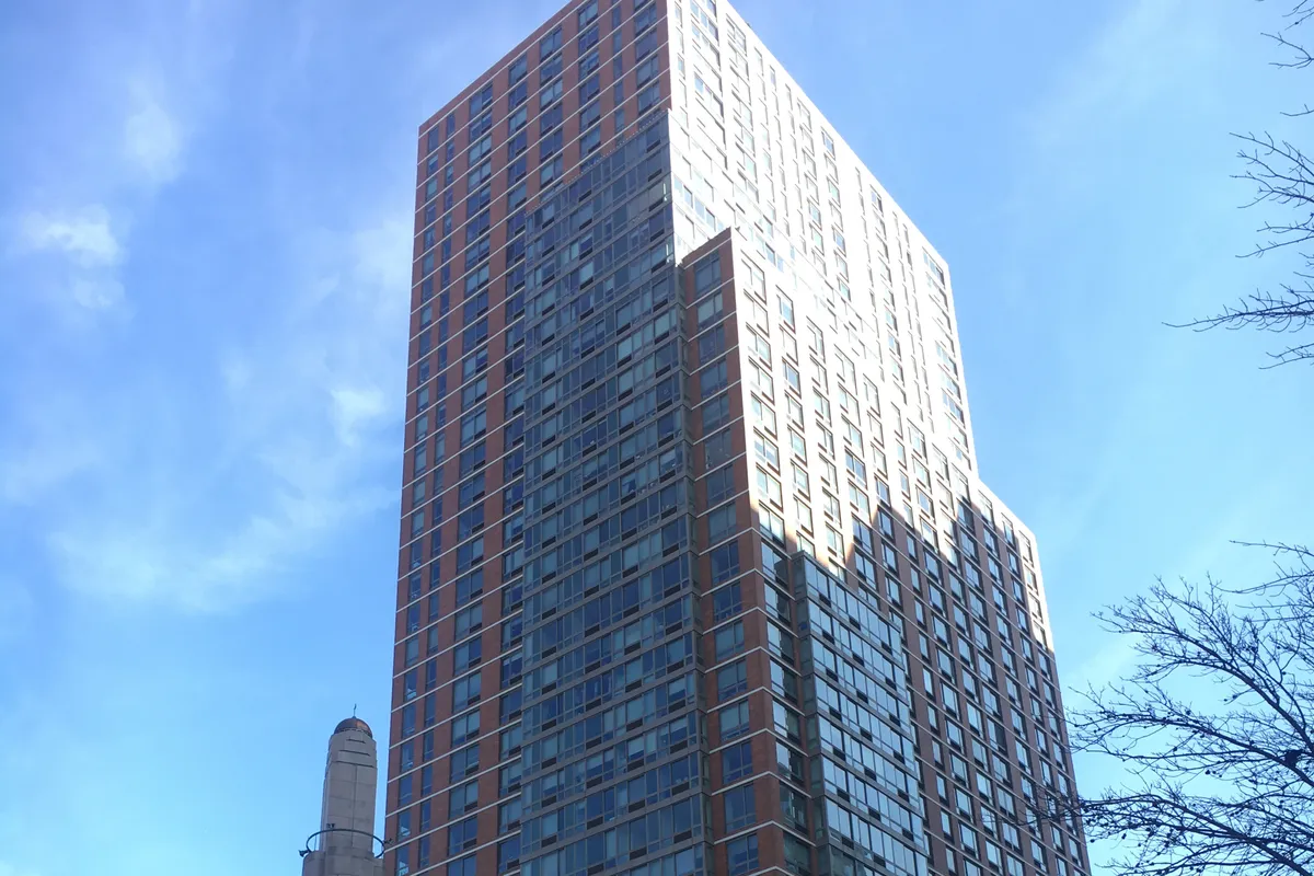 One Carnegie Hill, a red-brick and glass tower on East 96th Street, rising beside the minaret of the Islamic Cultural Center of New York