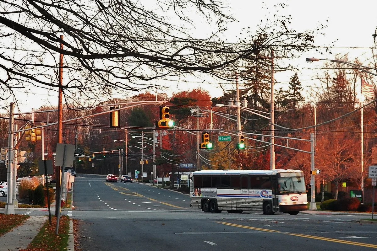 Chestnut Ridge Road at Grand Avenue in Montvale at dusk, about a mile north of the community, with a commuter bus crossing (not the building/community)