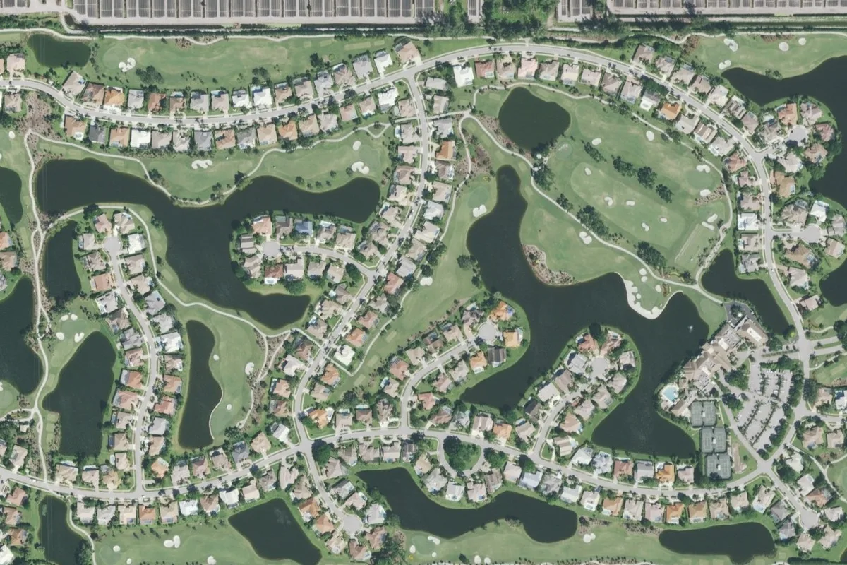 Aerial view of Stonebridge Country Club in West Boca Raton, with curving streets of single-family homes wrapped around lakes and golf fairways