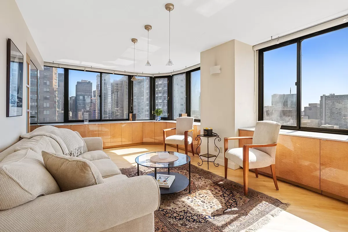 Corner living room framed by wraparound windows