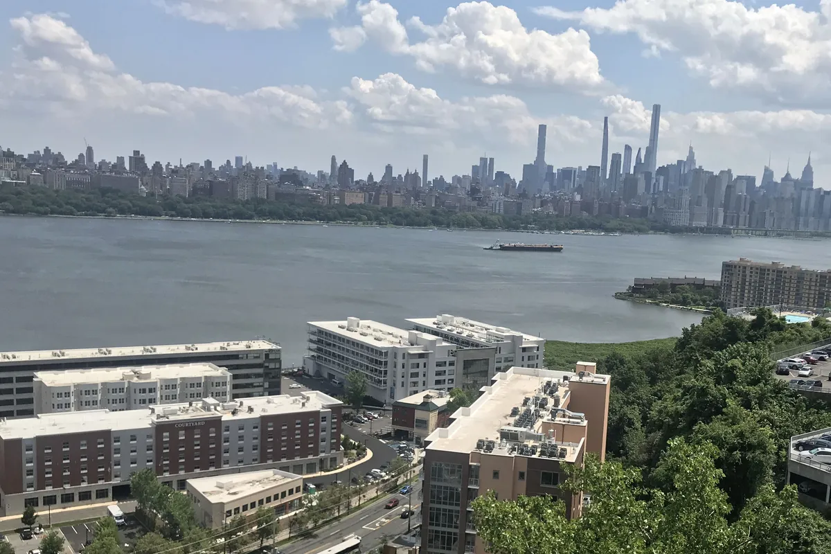 The Glass House and its neighbors at Edgewater Harbor, with Midtown Manhattan's towers across the river
