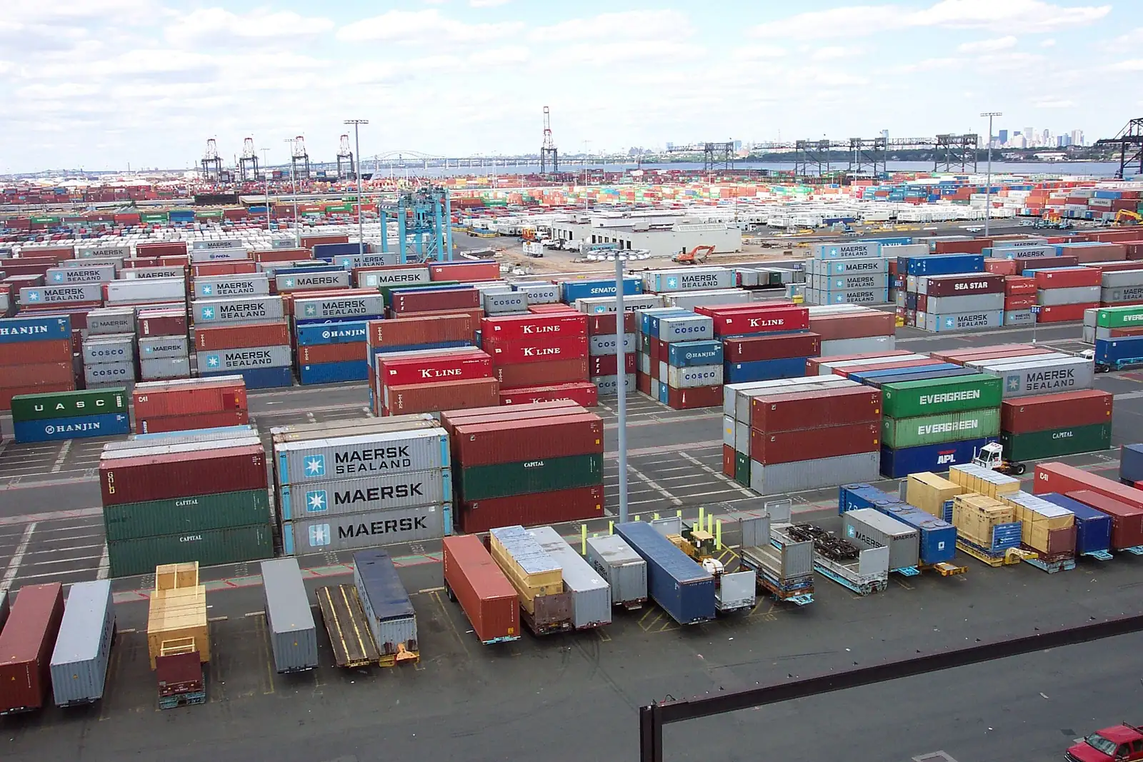Container stacks at Port Newark–Elizabeth with the Manhattan skyline beyond